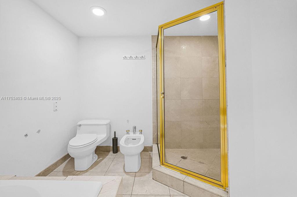 8925 Collins Avenue, Unit 2E Surfside, FL 33154 - Photo 24 of 46 a bathroom with a toilet and a shower