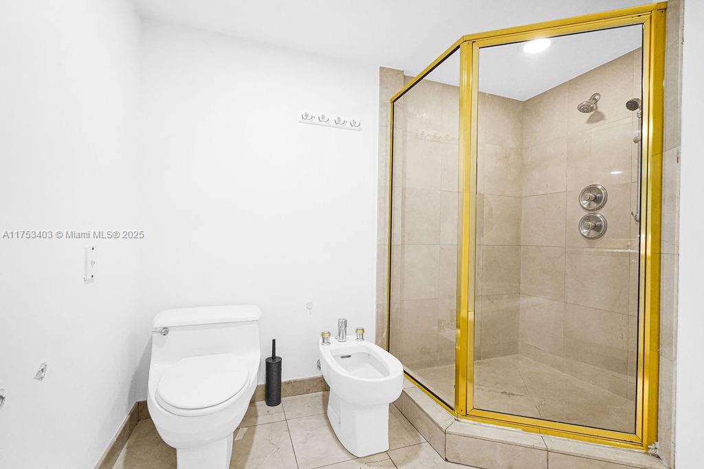 8925 Collins Avenue, Unit 2E Surfside, FL 33154 - Photo 26 of 46 a bathroom with a toilet and a shower