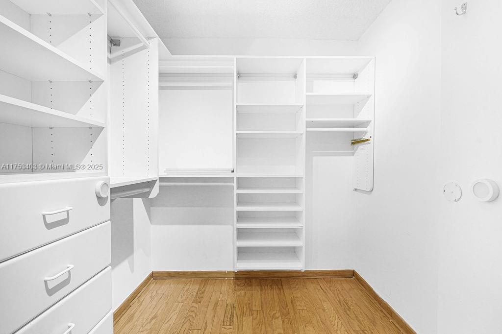 8925 Collins Avenue, Unit 2E Surfside, FL 33154 - Photo 27 of 46 a view of walk in closet with empty racks