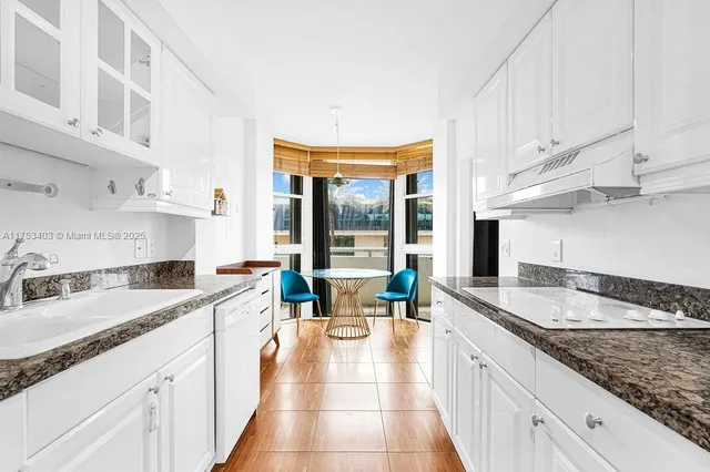 a kitchen with granite countertop a sink and a cabinets