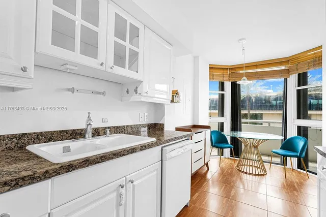 a balcony with table and chairs