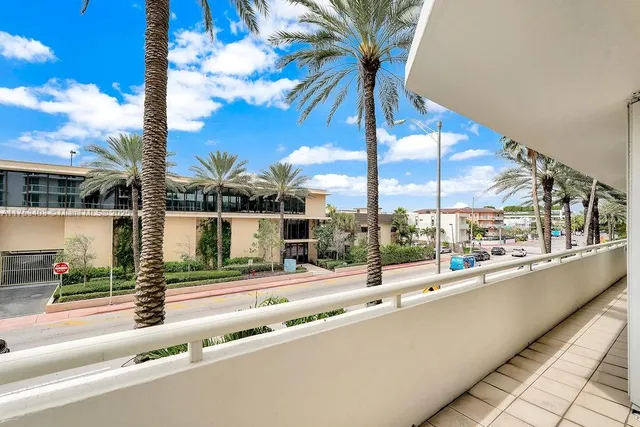 a view of a balcony with palm trees