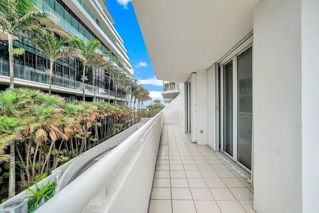 a living room with lots of furniture and chandelier
