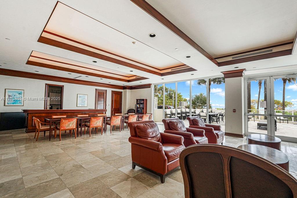 8925 Collins Avenue, Unit 2E Surfside, FL 33154 - Photo 38 of 46 a living room with lots of furniture and chandelier