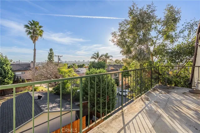a view of a balcony with wooden floor