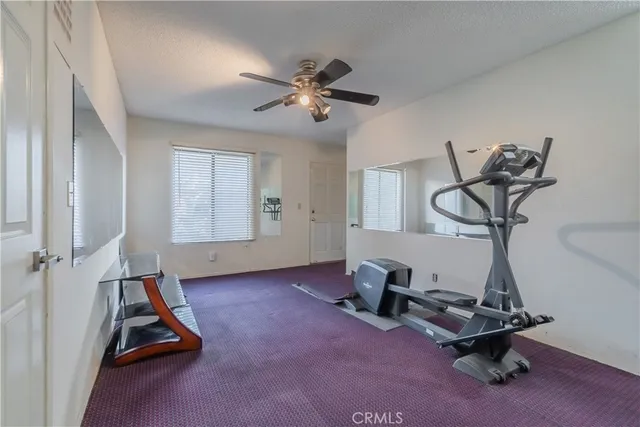 a room with gym equipment and windows