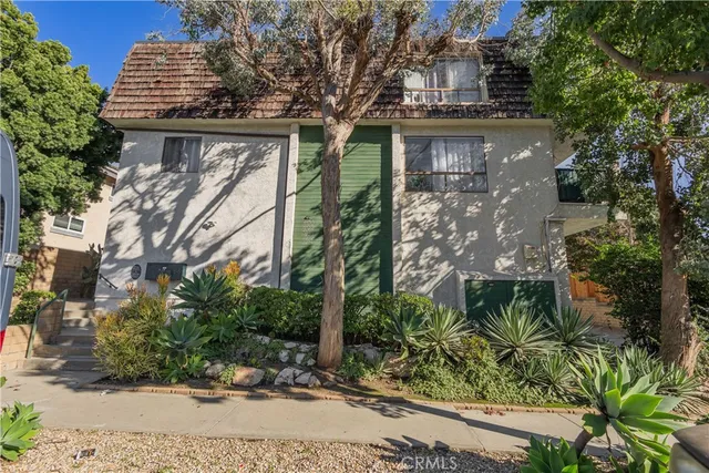 a view of a house with a tree
