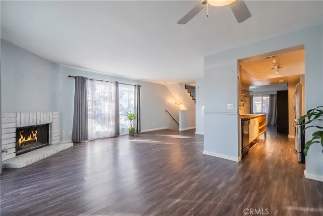 a view empty room with wooden floor and a fireplace