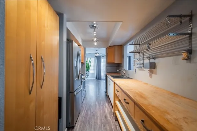 a view of a kitchen with a sink and wooden floor