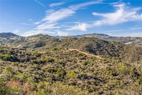 a view of a yard with mountains in the background