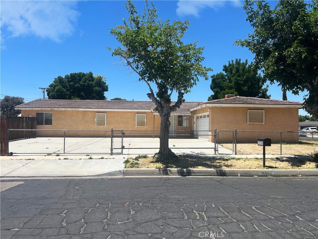 15558 Del Rey Drive Victorville, CA 92395 - Photo 1 of 30 a house view with a sitting space fire pit and large trees