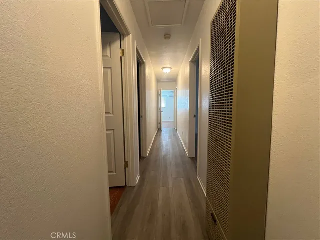 a view of hallway with wooden floor