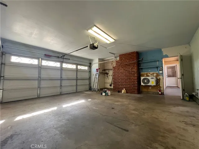 a view of a livingroom with fireplace and window
