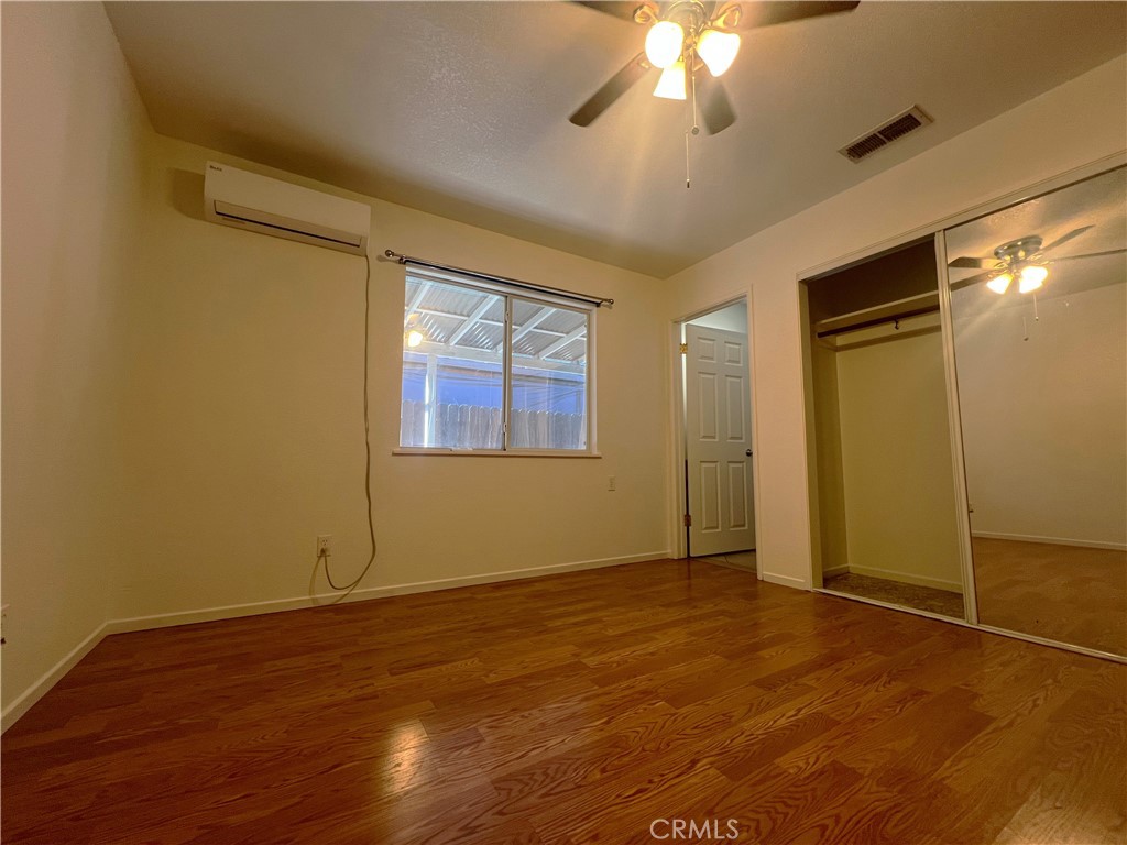 15558 Del Rey Drive Victorville, CA 92395 - Photo 17 of 32 a view of an empty room with wooden floor and a window