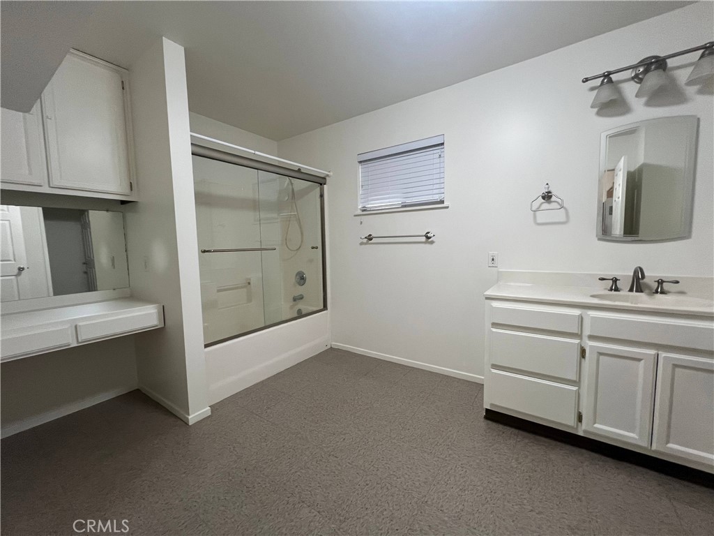 15558 Del Rey Drive Victorville, CA 92395 - Photo 21 of 30 a bathroom with a double vanity sink a mirror and shower