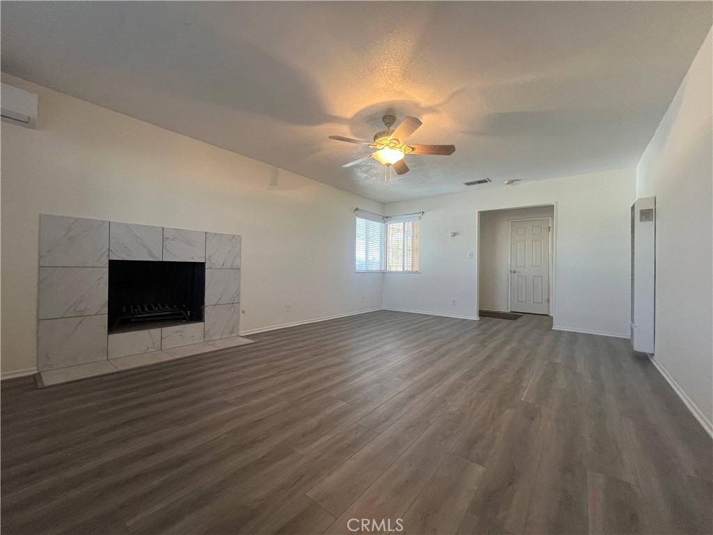 15558 Del Rey Drive Victorville, CA 92395 - Photo 5 of 30 an empty room with wooden floor and chandelier fan