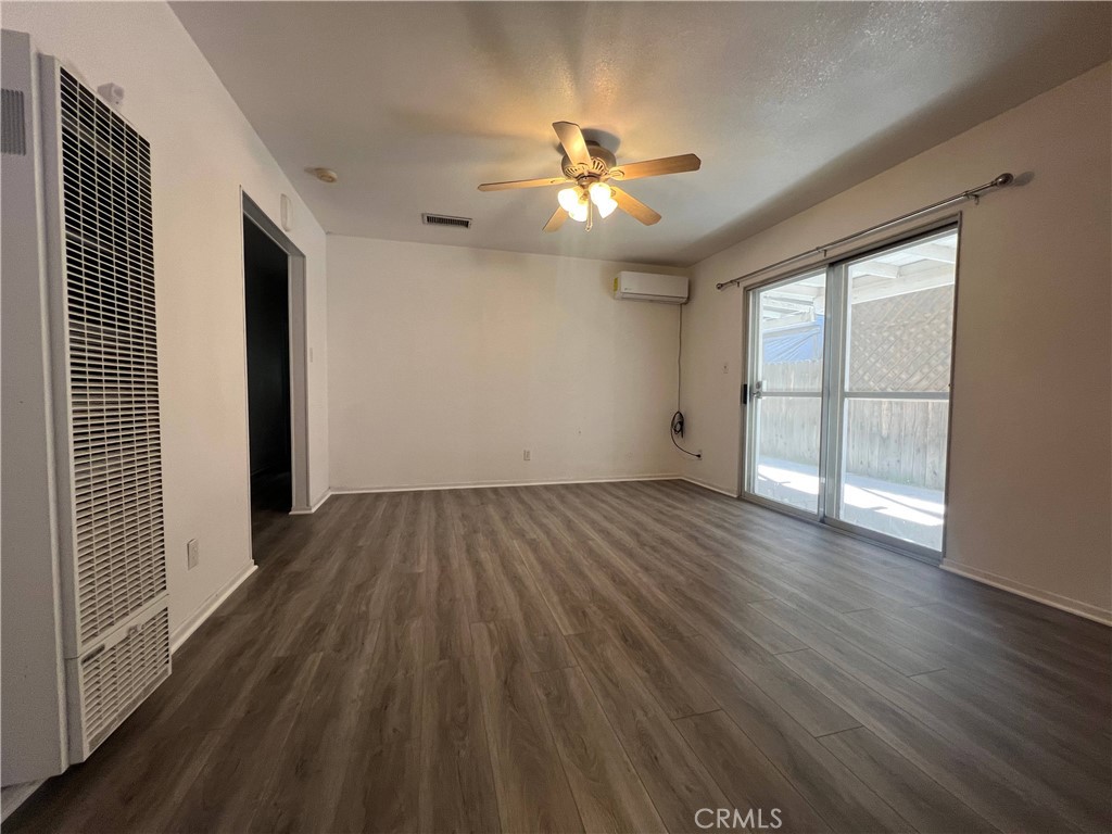 15558 Del Rey Drive Victorville, CA 92395 - Photo 7 of 32 wooden floor in an empty room with a window