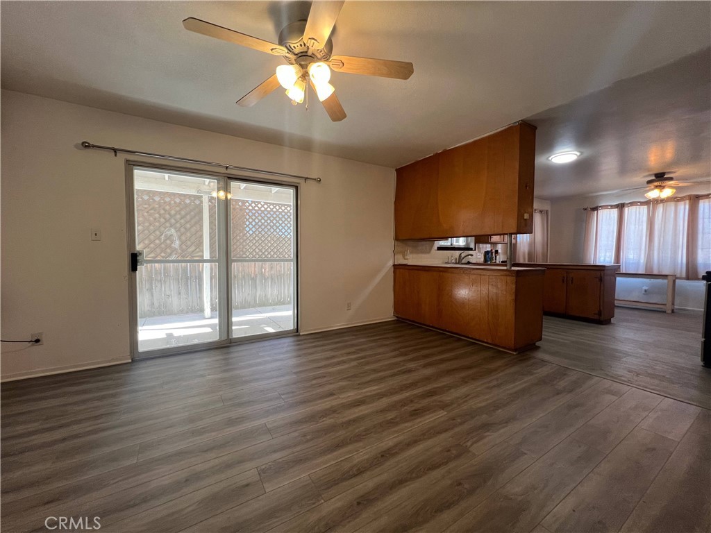 15558 Del Rey Drive Victorville, CA 92395 - Photo 8 of 32 a view of a kitchen with a stove wooden cabinets and a ceiling fan