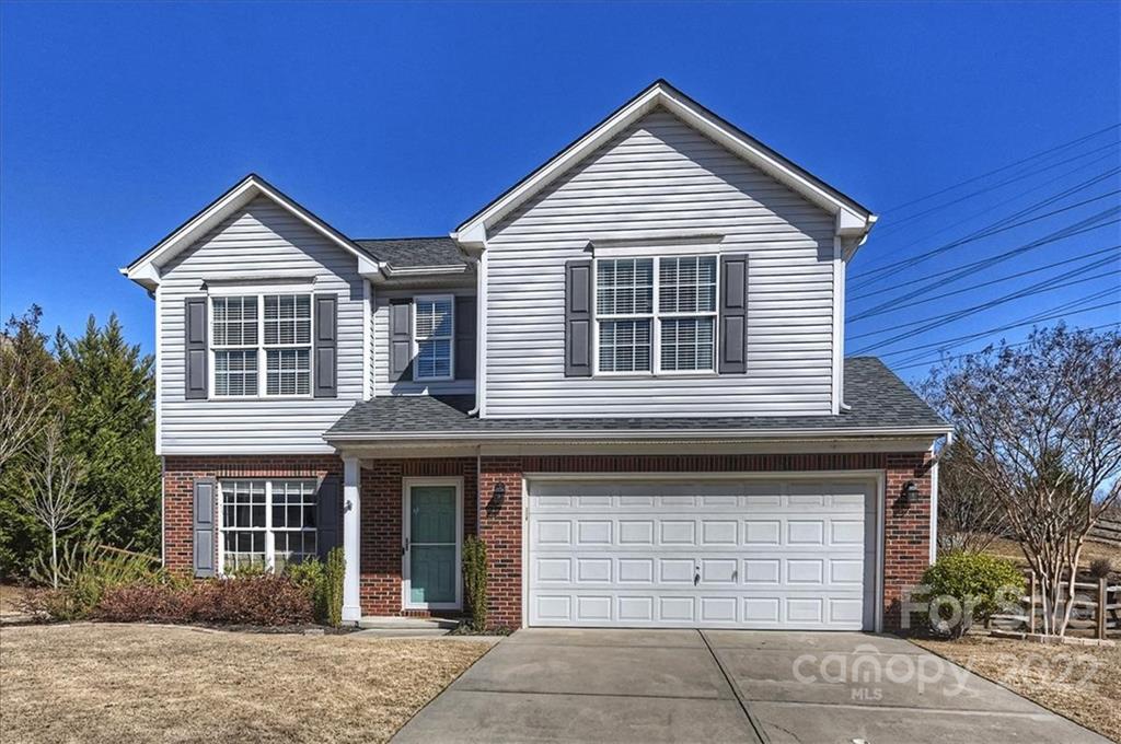 7671 Black Hawk Lane Tega Cay, SC 29708 - Photo 1 of 45 a front view of a house with a garage and yard