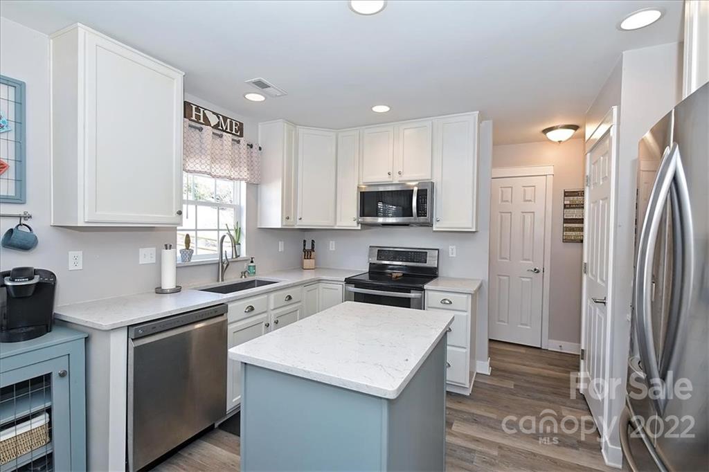 7671 Black Hawk Lane Tega Cay, SC 29708 - Photo 16 of 45 a kitchen with a sink a stove a refrigerator and cabinets