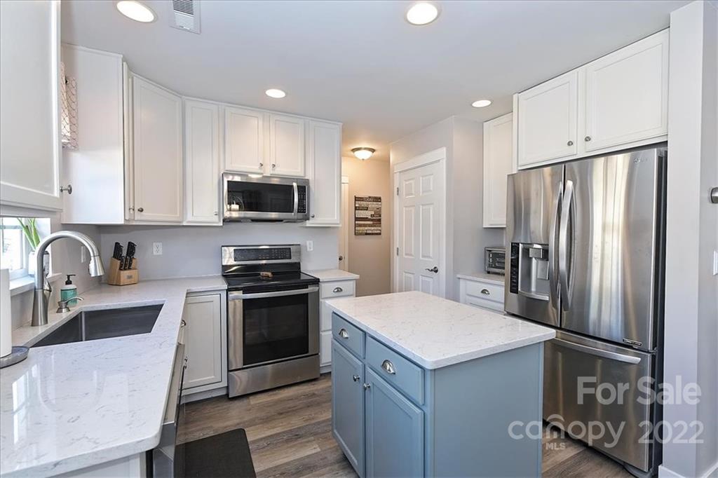 7671 Black Hawk Lane Tega Cay, SC 29708 - Photo 17 of 45 a kitchen with a refrigerator sink and stove top oven