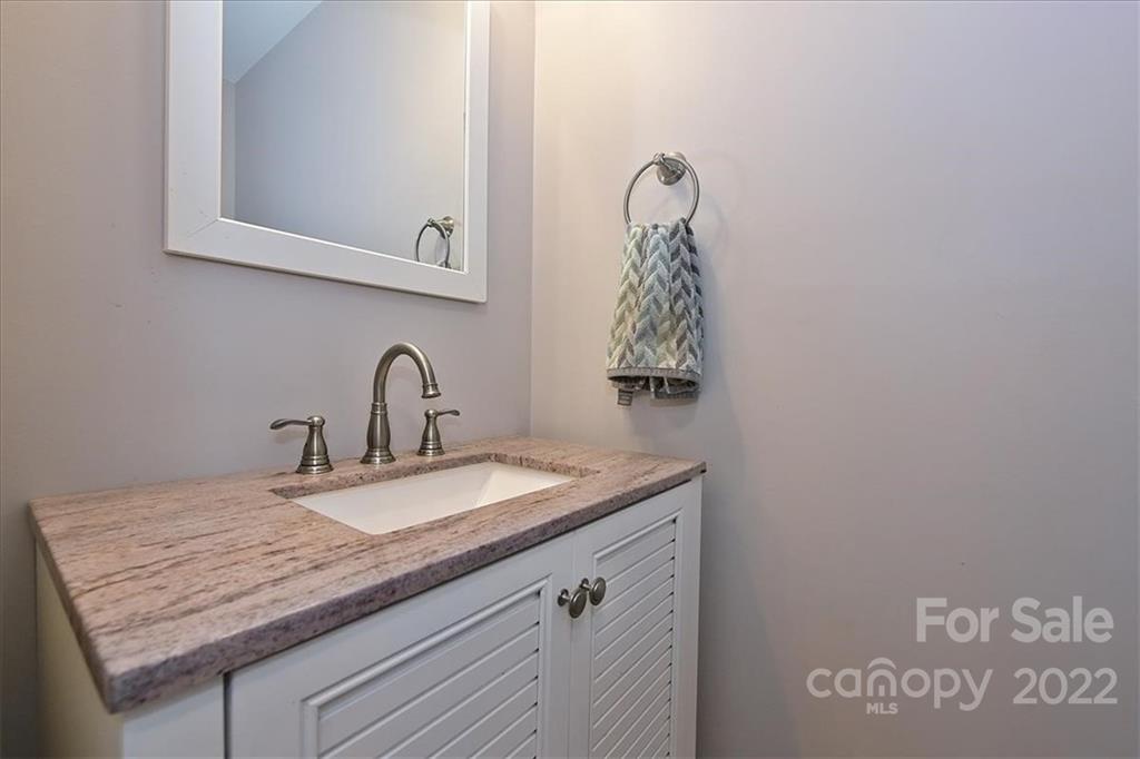7671 Black Hawk Lane Tega Cay, SC 29708 - Photo 21 of 45 a bathroom with a granite countertop sink and a mirror