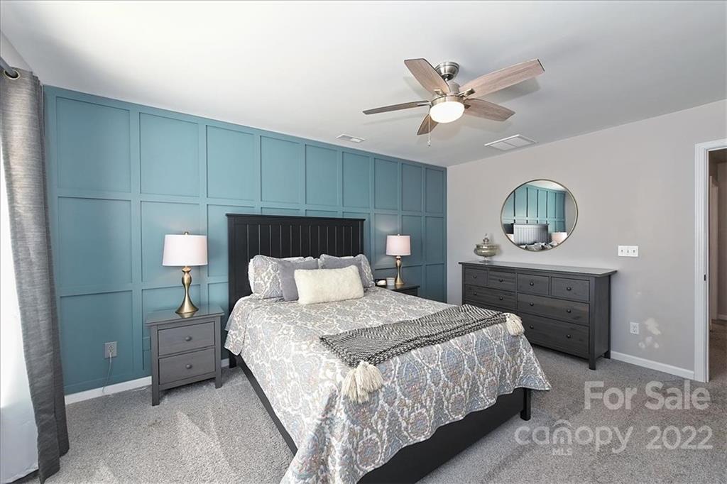 7671 Black Hawk Lane Tega Cay, SC 29708 - Photo 25 of 45 a bedroom with a bed and a chandelier