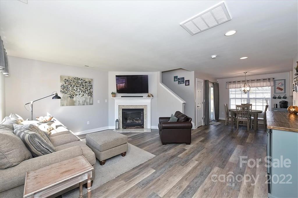7671 Black Hawk Lane Tega Cay, SC 29708 - Photo 5 of 45 a living room with furniture or couch and a fireplace