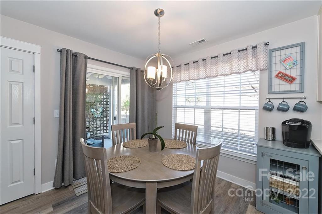 7671 Black Hawk Lane Tega Cay, SC 29708 - Photo 10 of 45 a view of a dining room with furniture window and wooden floor