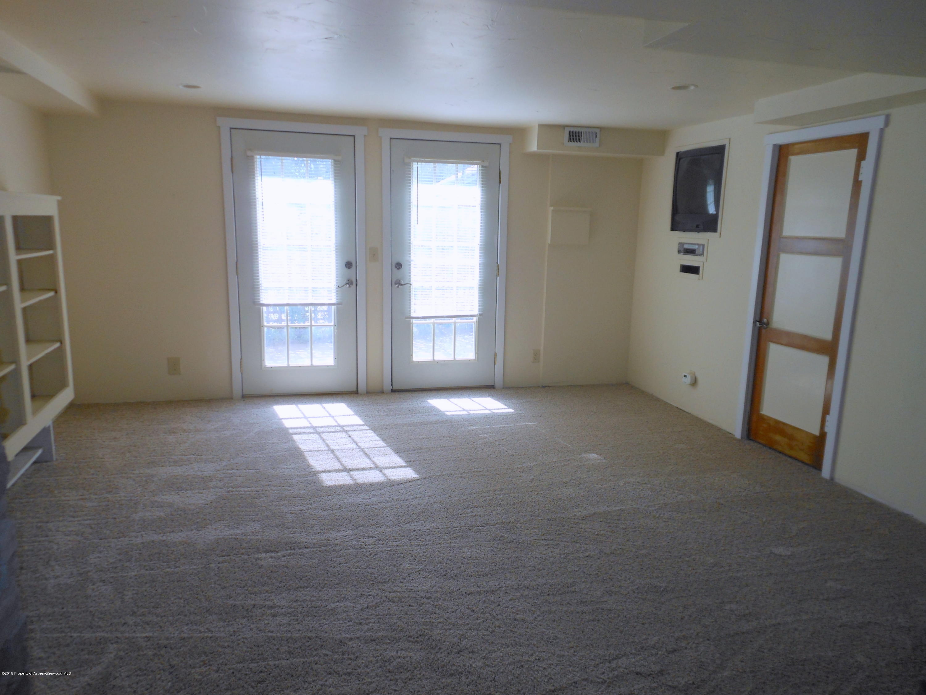 300 East 7th Street Rifle, CO 81650 - Photo 13 of 24 an empty room with windows