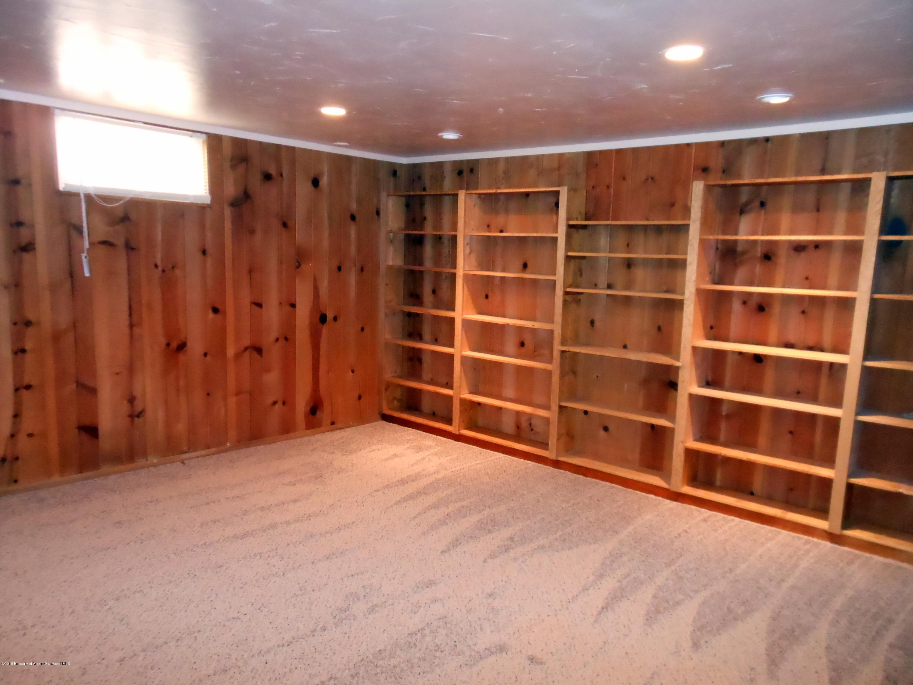 300 East 7th Street Rifle, CO 81650 - Photo 19 of 24 a view of an empty room with a wooden shelves and cabinets