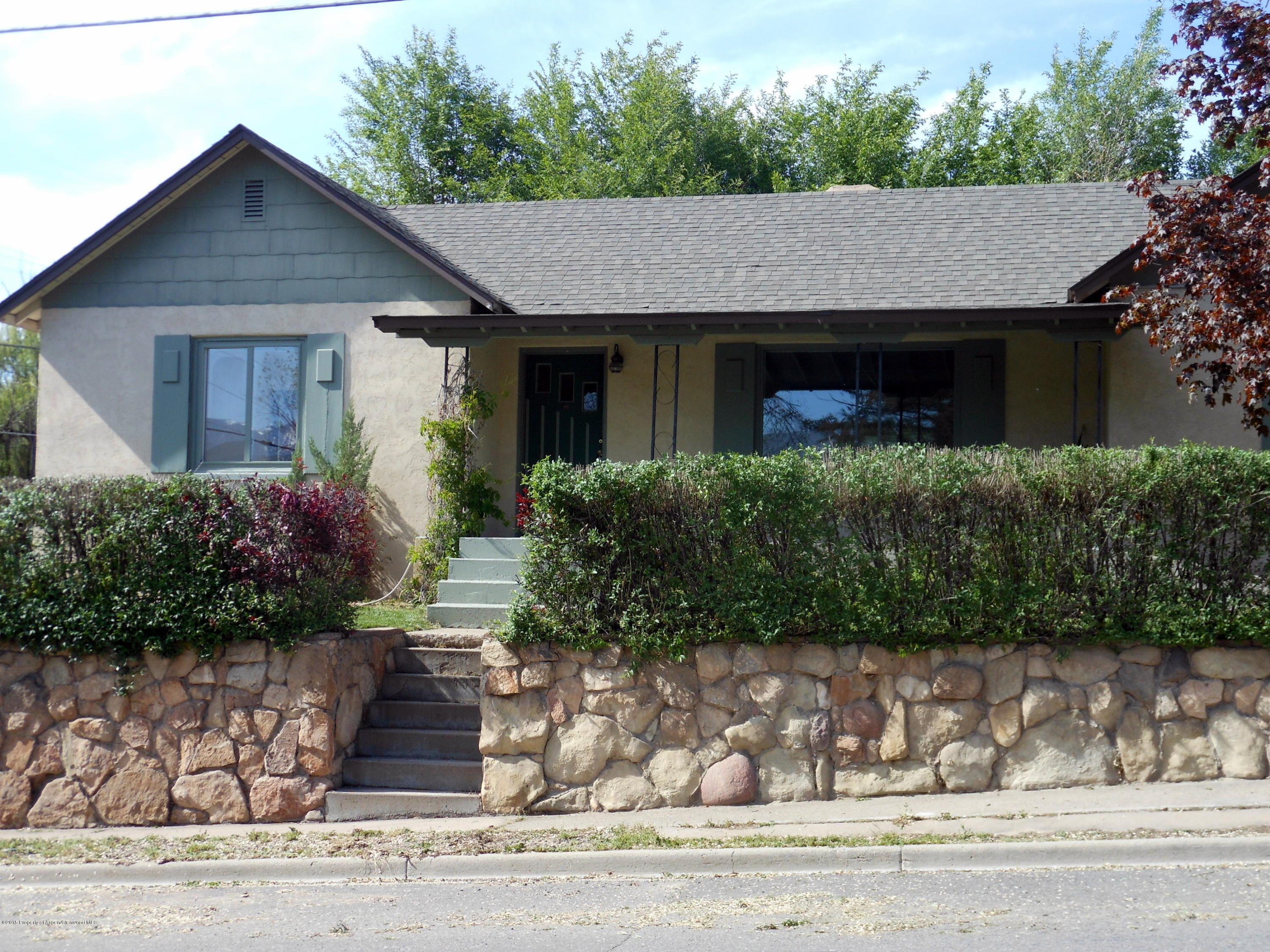 300 East 7th Street Rifle, CO 81650 - Photo 2 of 24 a front view of a house with a yard and garage
