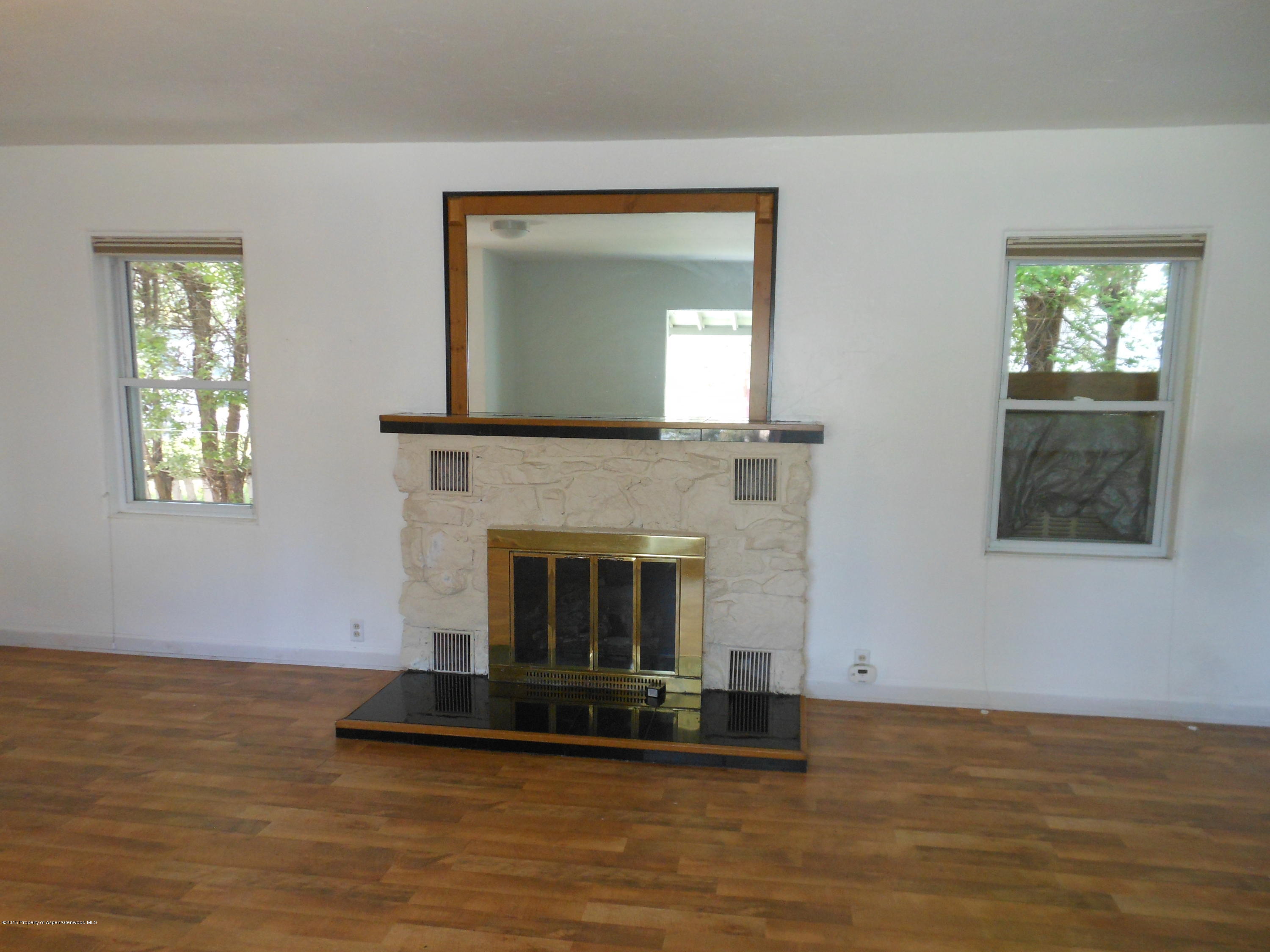 300 East 7th Street Rifle, CO 81650 - Photo 10 of 24 a living room with furniture and a fireplace