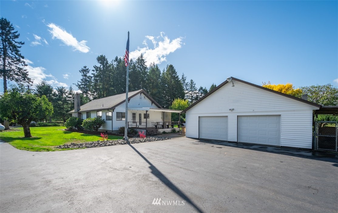 1311 Koontz Road Chehalis, WA 98532 - Photo 1 of 16 a view of a house with a big yard and large trees