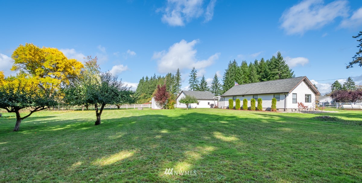 1311 Koontz Road Chehalis, WA 98532 - Photo 3 of 16 a view of a garden with a house in the background