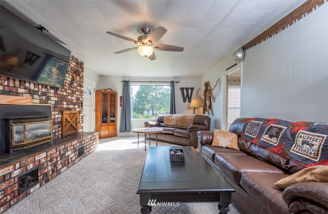 1311 Koontz Road Chehalis, WA 98532 - Photo 10 of 16 a living room with furniture fireplace and flat screen tv