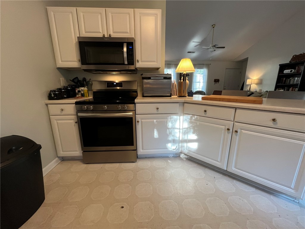 116 Arbors Court Central, SC 29630 - Photo 7 of 27 A compact kitchen with sleek stainless steel appliances offers both functionality and style.