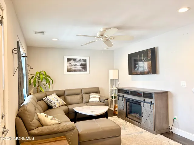 a living room with furniture a fireplace and a flat screen tv