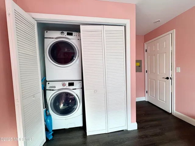 a utility room with washing machine and a view of bedroom