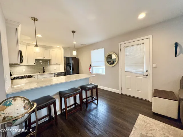 a large kitchen with a table and chairs