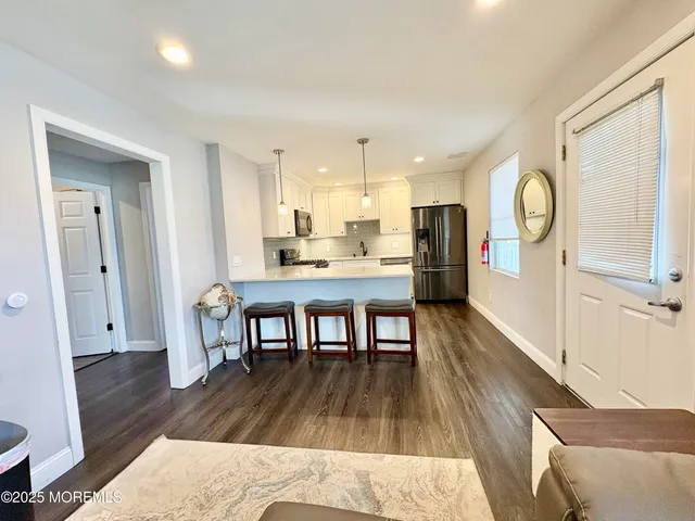 a view of a dining room with furniture and a wooden floor