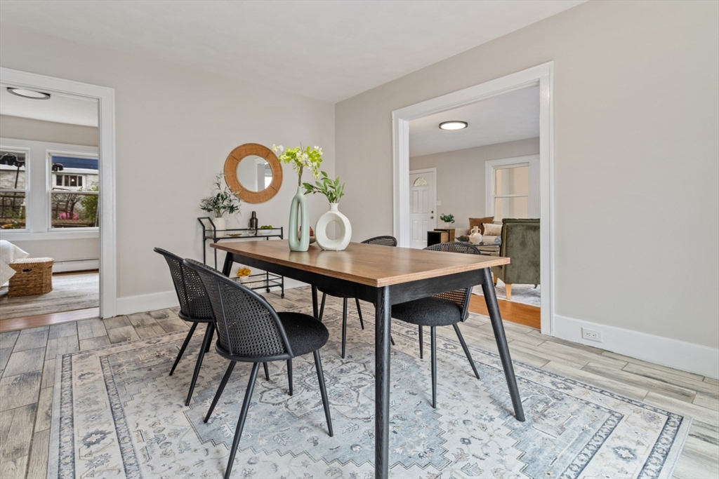 50 Shawmut Street Lawrence, MA 01841 - Photo 11 of 38 a dining room with a wooden table and chairs
