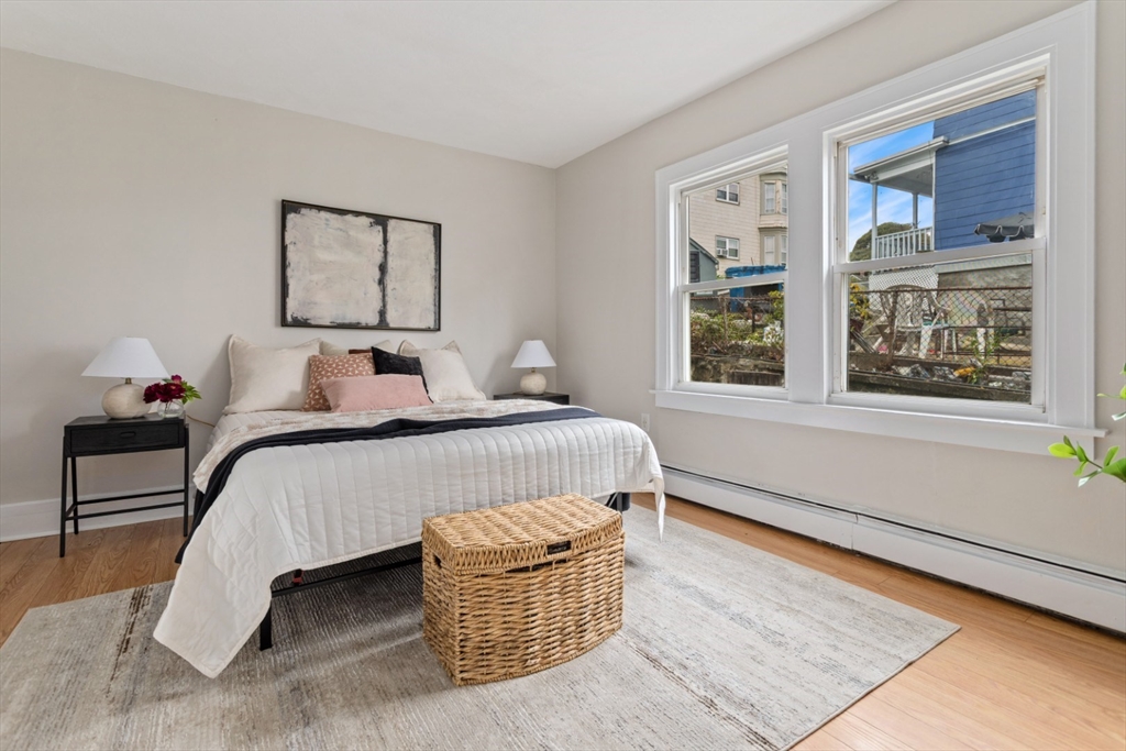 50 Shawmut Street Lawrence, MA 01841 - Photo 20 of 38 a bedroom with a bed and wooden floor