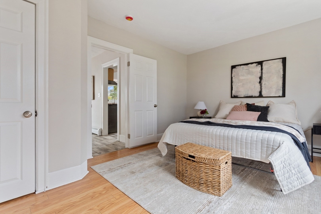 50 Shawmut Street Lawrence, MA 01841 - Photo 22 of 38 a bedroom with bed and wooden floor