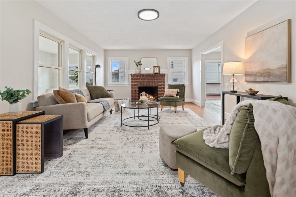 50 Shawmut Street Lawrence, MA 01841 - Photo 4 of 38 a living room with furniture a fireplace and large windows