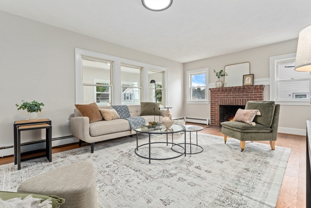 50 Shawmut Street Lawrence, MA 01841 - Photo 5 of 38 a living room with furniture a fireplace and a table