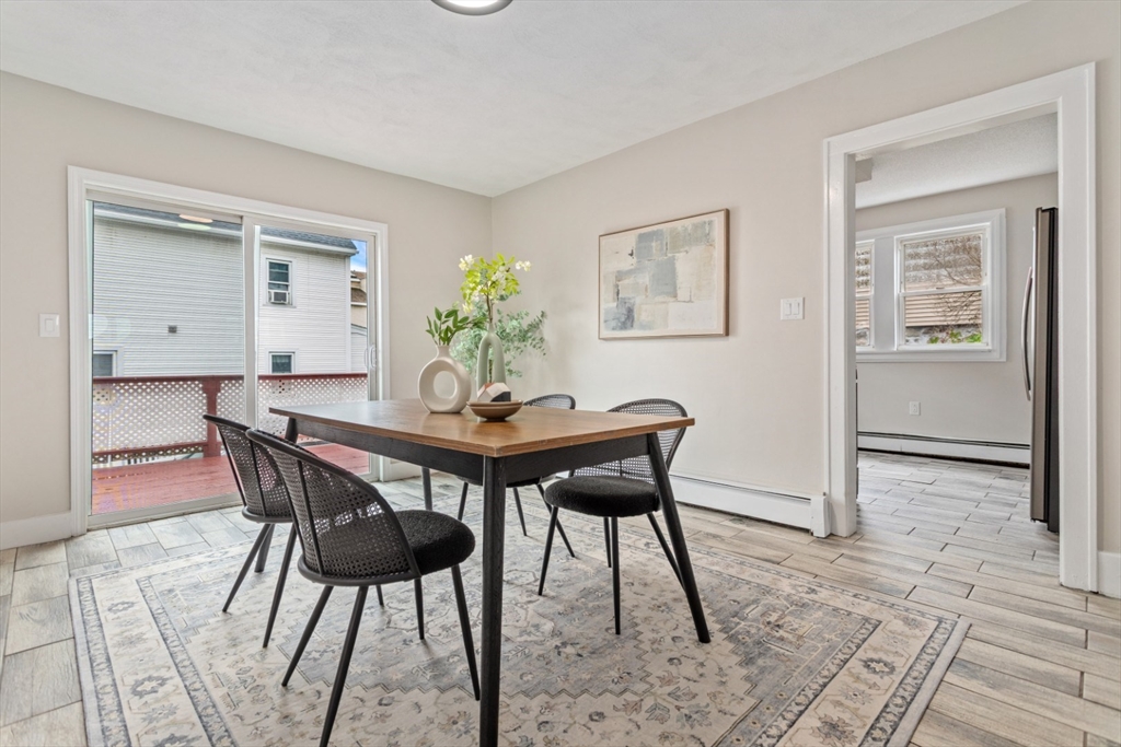 50 Shawmut Street Lawrence, MA 01841 - Photo 10 of 38 a view of a dining room with furniture and wooden floor