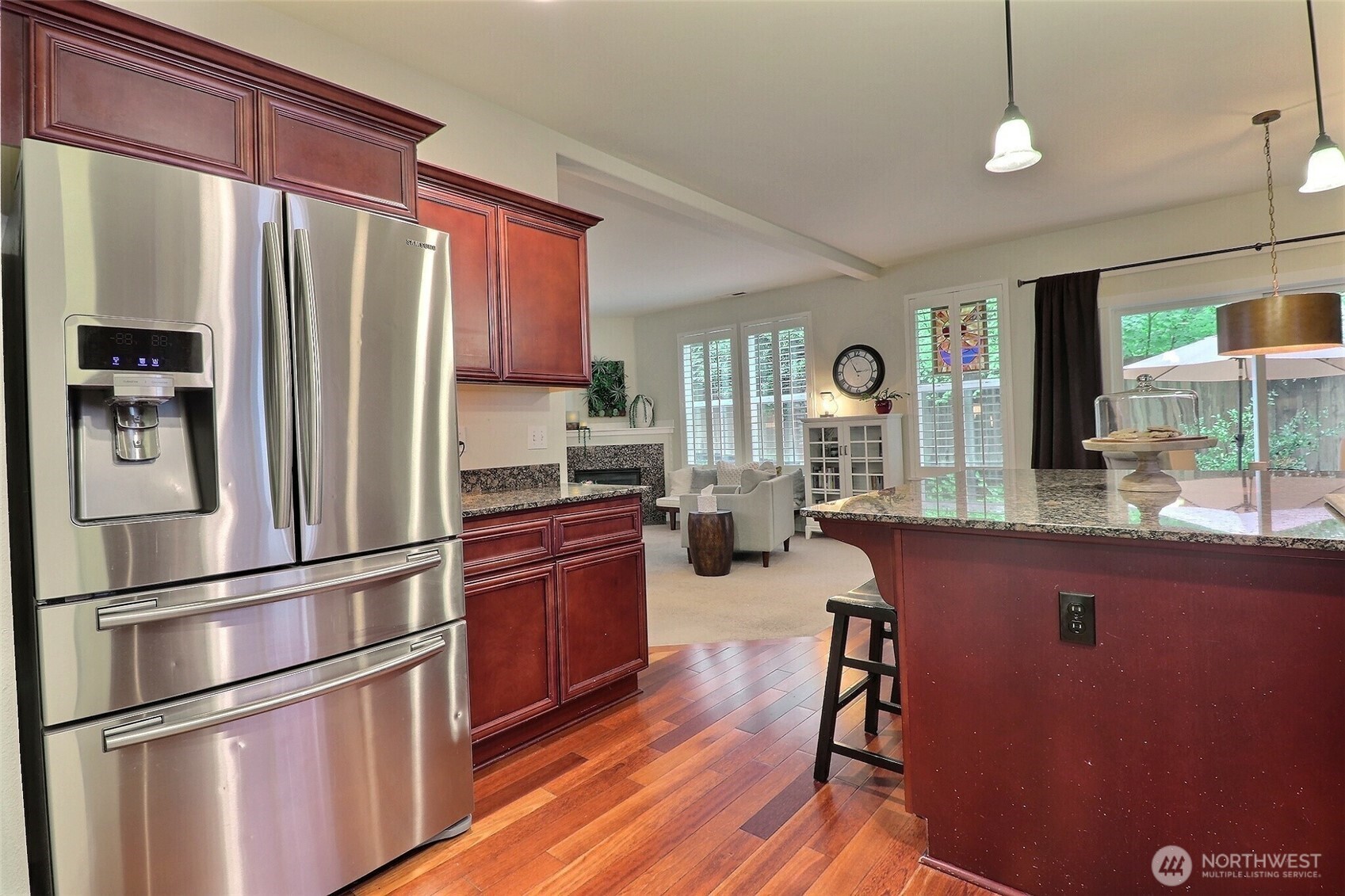 19776 Mountain Ridge Road Southeast Monroe, WA 98272 - Photo 16 of 40 a kitchen with stainless steel appliances granite countertop a refrigerator a stove and a wooden floors