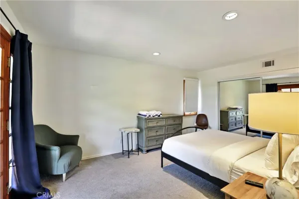 a spacious bathroom with a granite countertop sink and a mirror