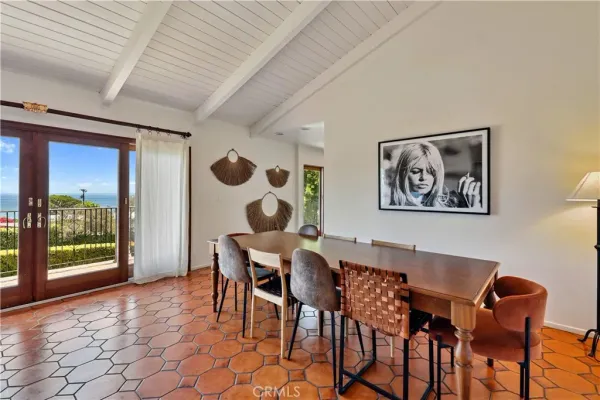 a kitchen with granite countertop a refrigerator a sink a stove top oven and cabinets